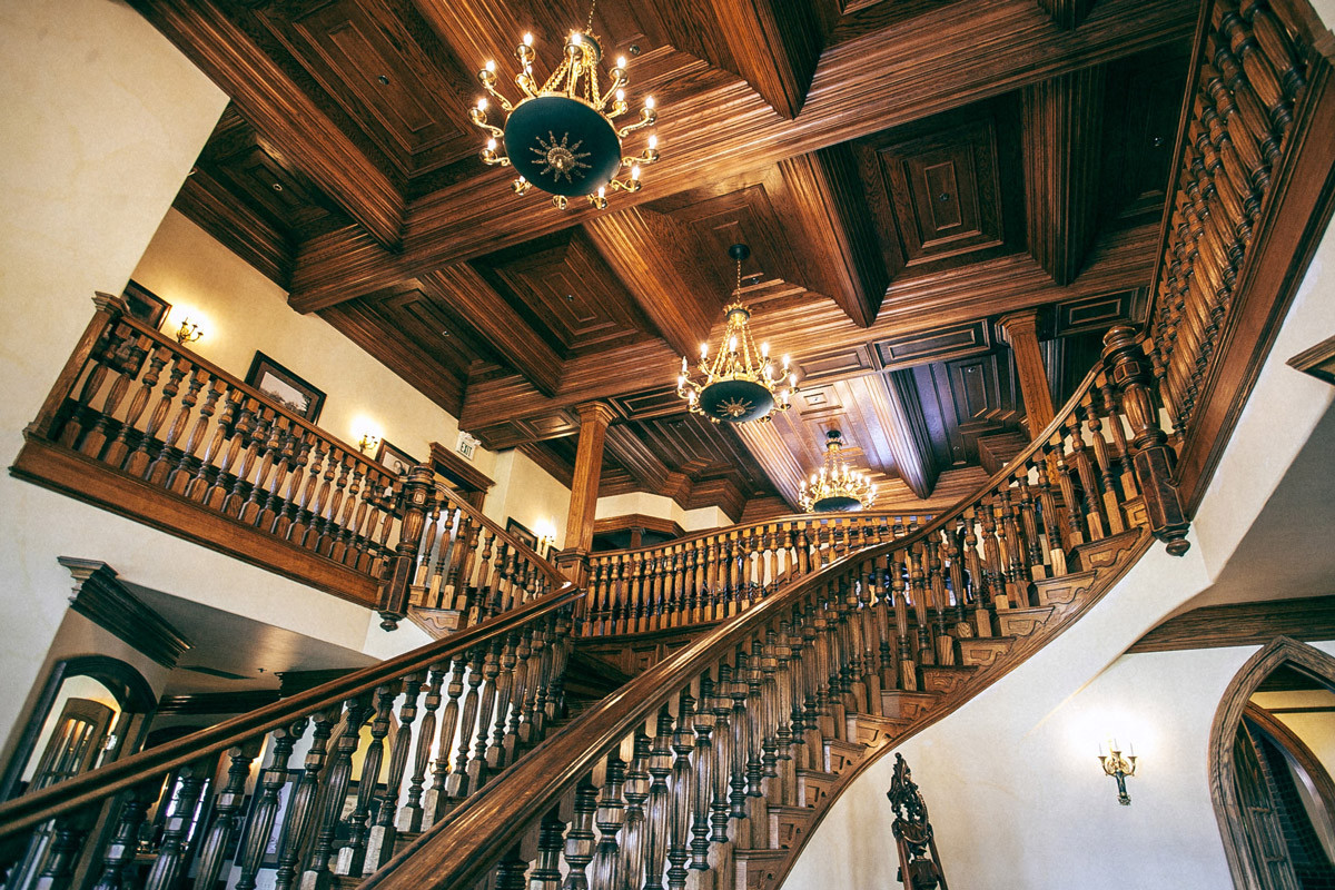 Historic interior design with wooden staircase and ceiling panels