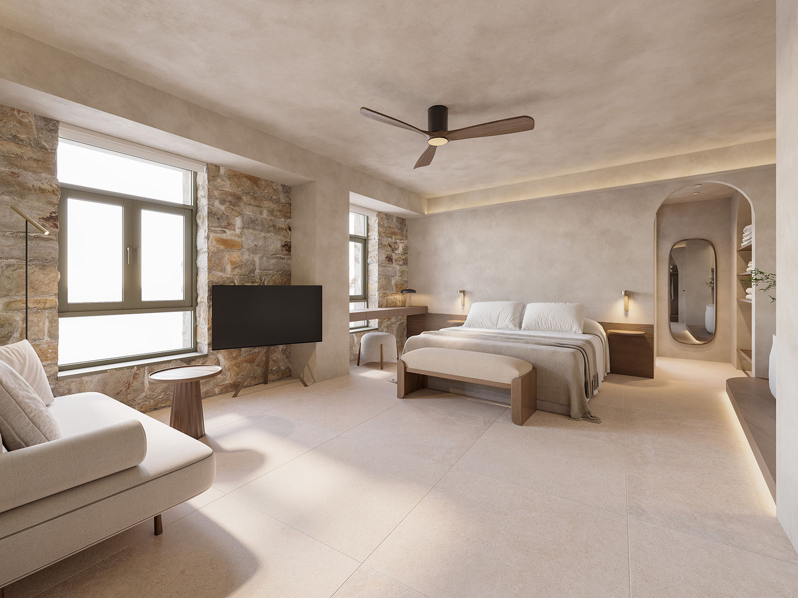 Wide hotel room render showing bed, sofa, exposed stone walls, arched openings and warm Mediterranean finishes